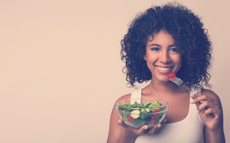 Mujer comiendo una ensalada de verduras 