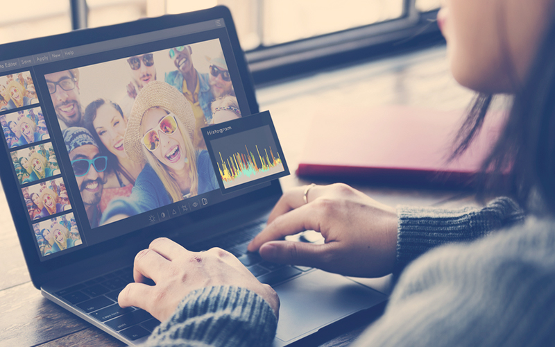 Mujer en un computador editando sus fotos