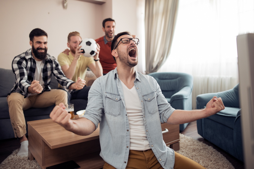 Grupo de amigos mirando un partido de fútbol