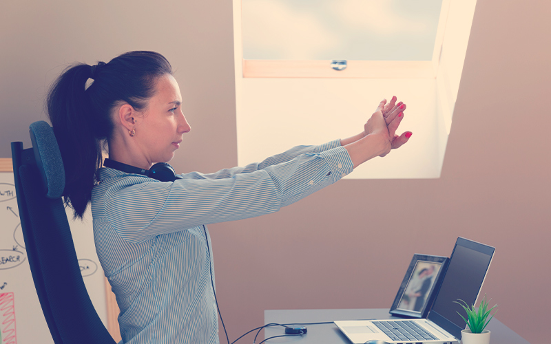 Hermosas mujeres haciendo ejercicios y estirando delante de una laptop. Trabajando en casa, concepto de salud.