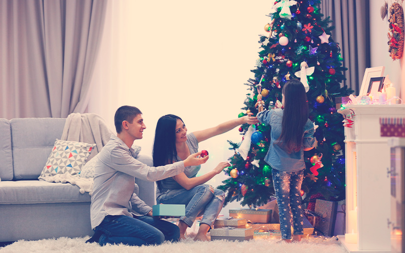 Familia decorando el árbol de Navidad