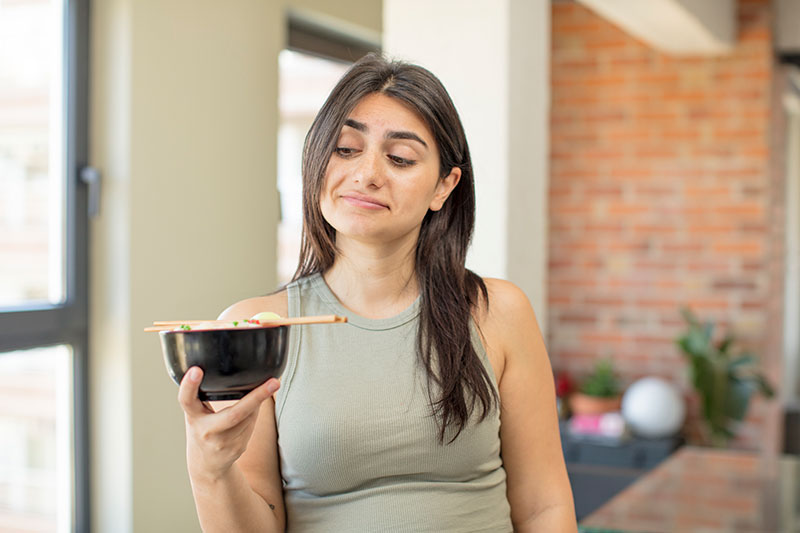 mujer indecisa comiendo